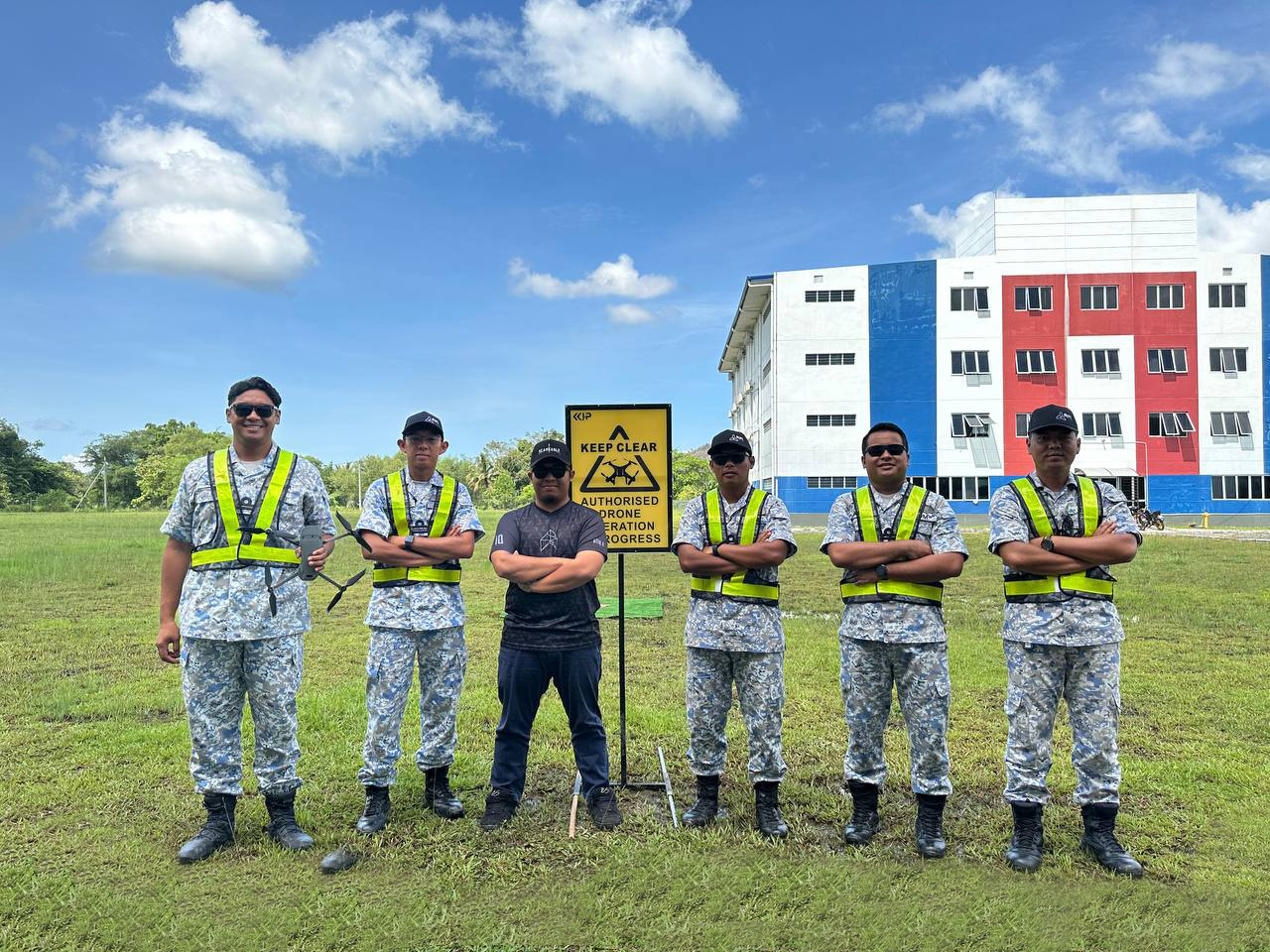 Drone trainees standing outdoors at facility