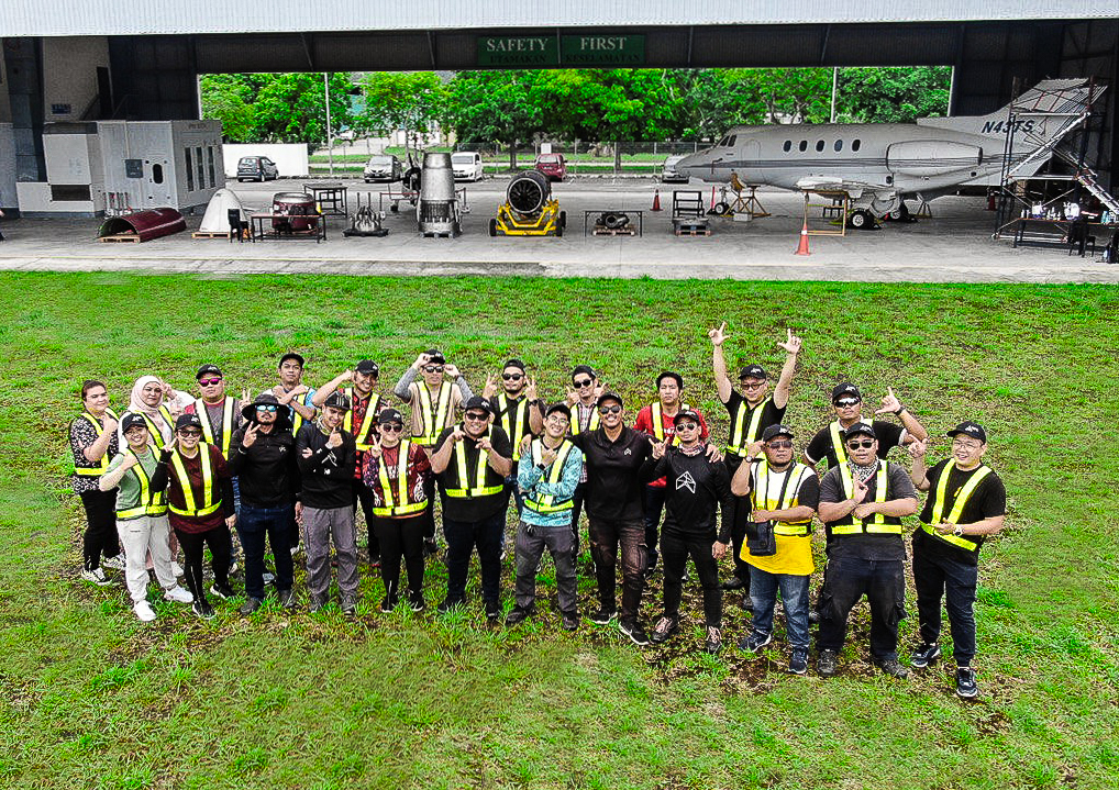 Drone team in field with aircraft